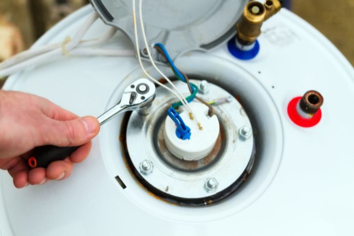 a person fixing a water heater