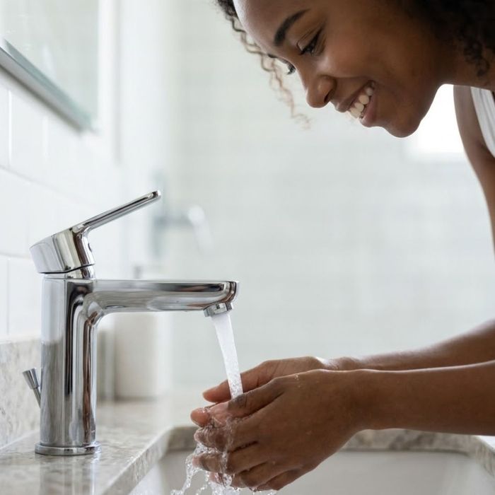 A woman washing her hands.