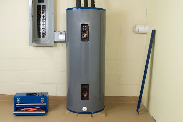 a gray water heater against a white wall