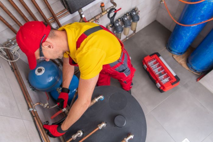 a man repairing a water heater