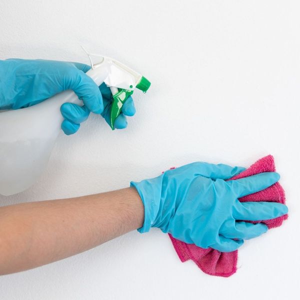 woman cleaning a wall