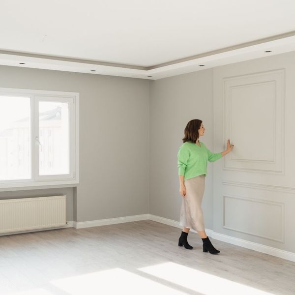 woman inspecting a wall
