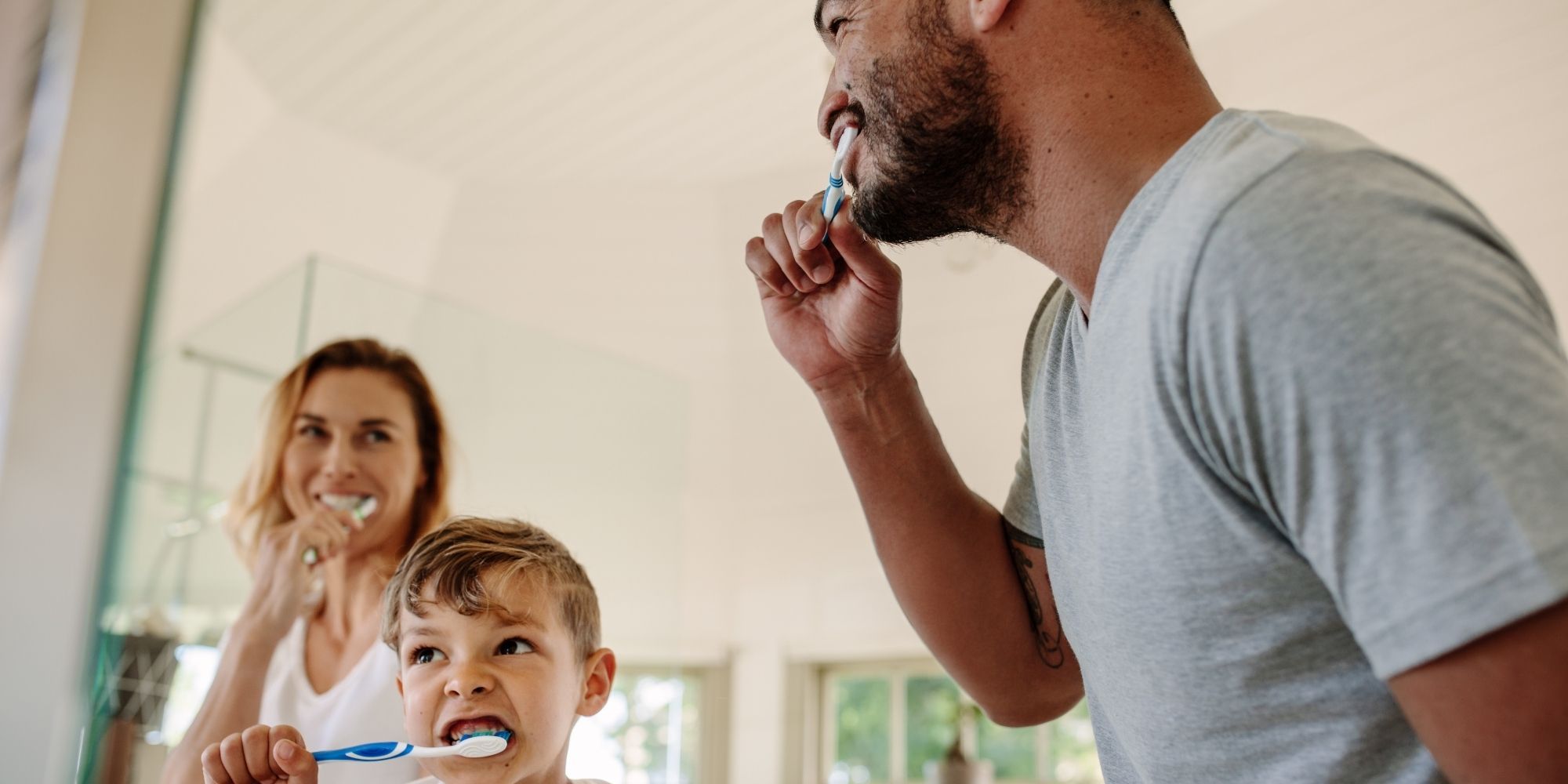 family brushing teeth in new bathroom