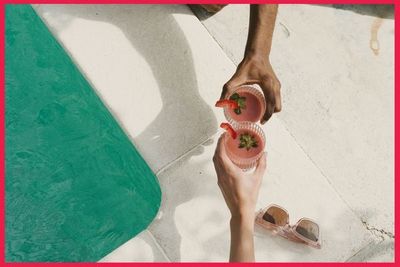 people have drinks sitting on side of pool people have drinks sitting on side of pool