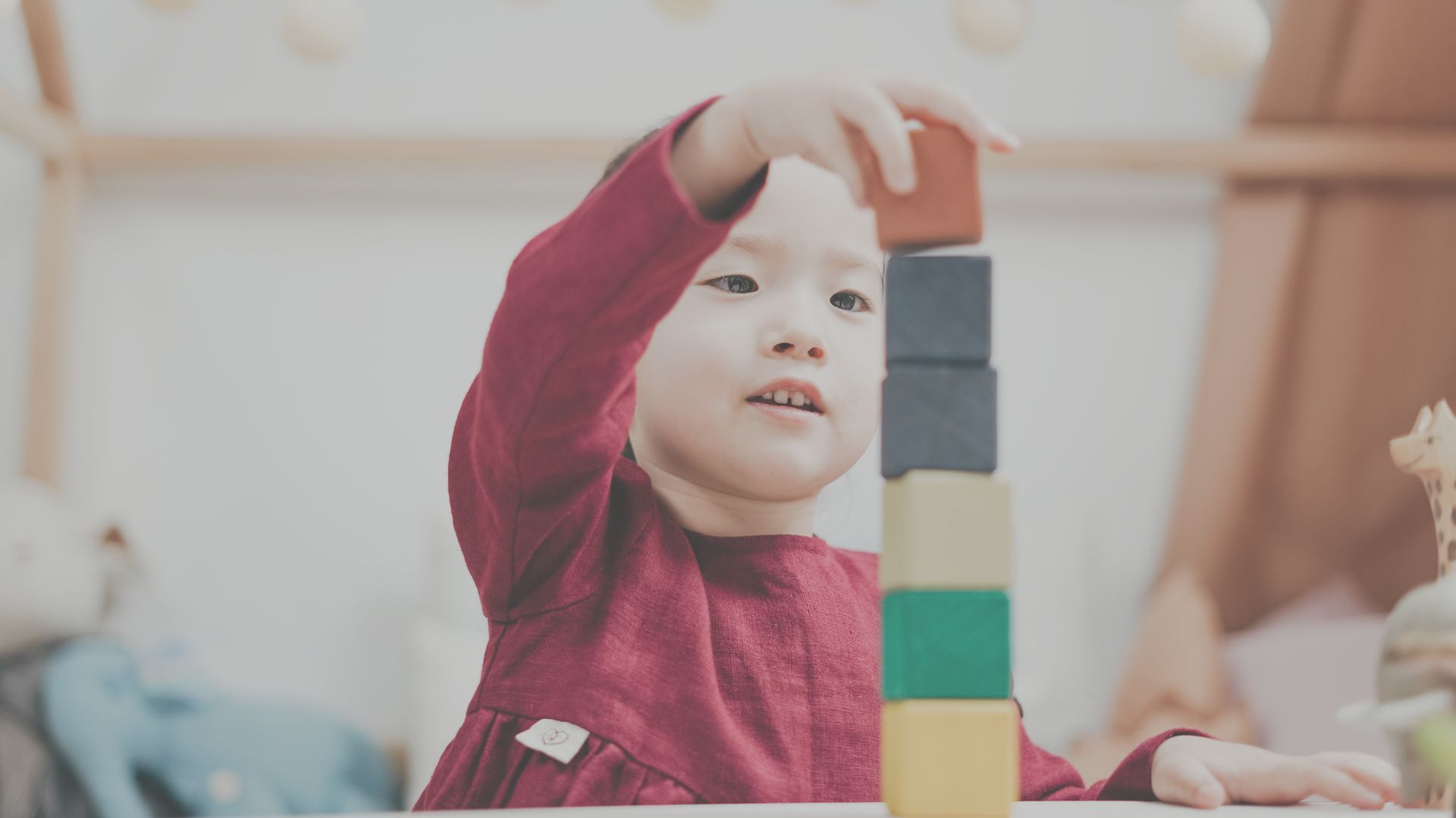 child stacking blocks