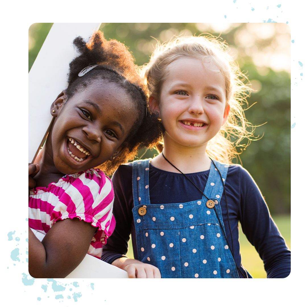 Young girls smiling and playing outdoors