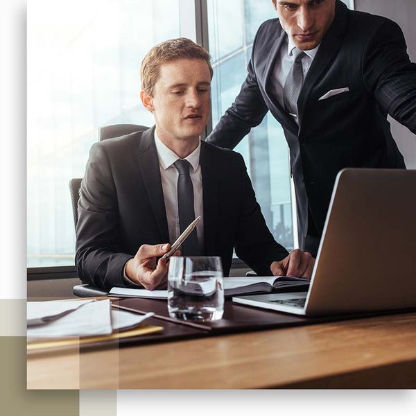 two lawyers looking at laptop and convening on a case