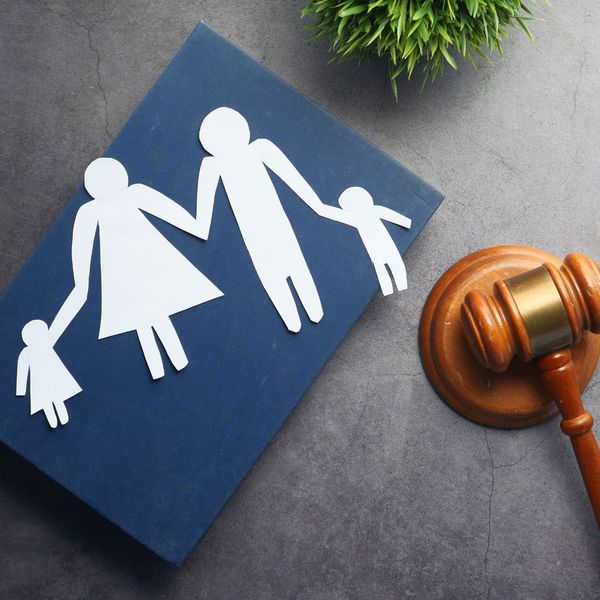 A paper cutout of a family next to a gavel