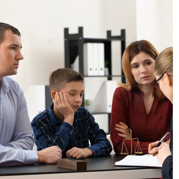 A couple with a child talking to an attorney