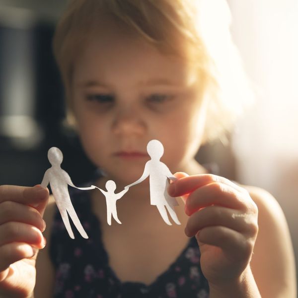 child looking at paper cutout of family