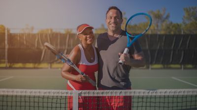 man and woman by tennis net