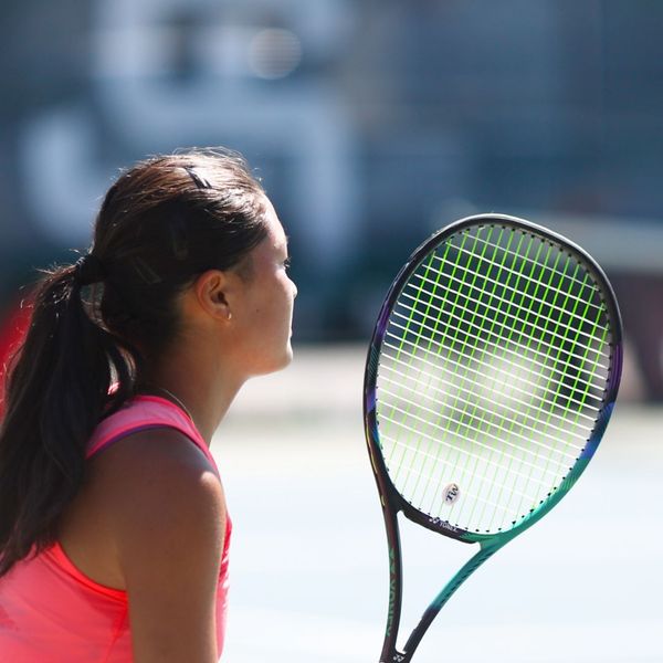 teenage girl playing tennis