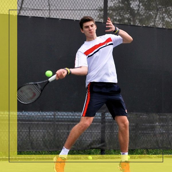 a teenager hitting a tennis ball