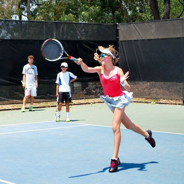 girl practicing tennis