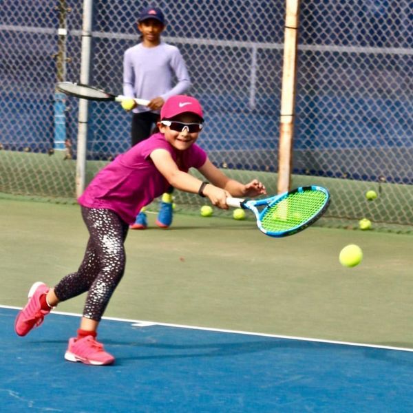 young girl in tennis program