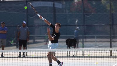 teen playing tennis at camp 