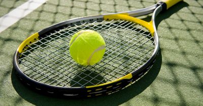 A tennis ball on a racket