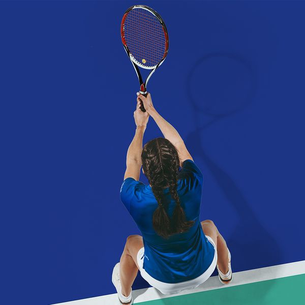 A woman poised with a tennis racket