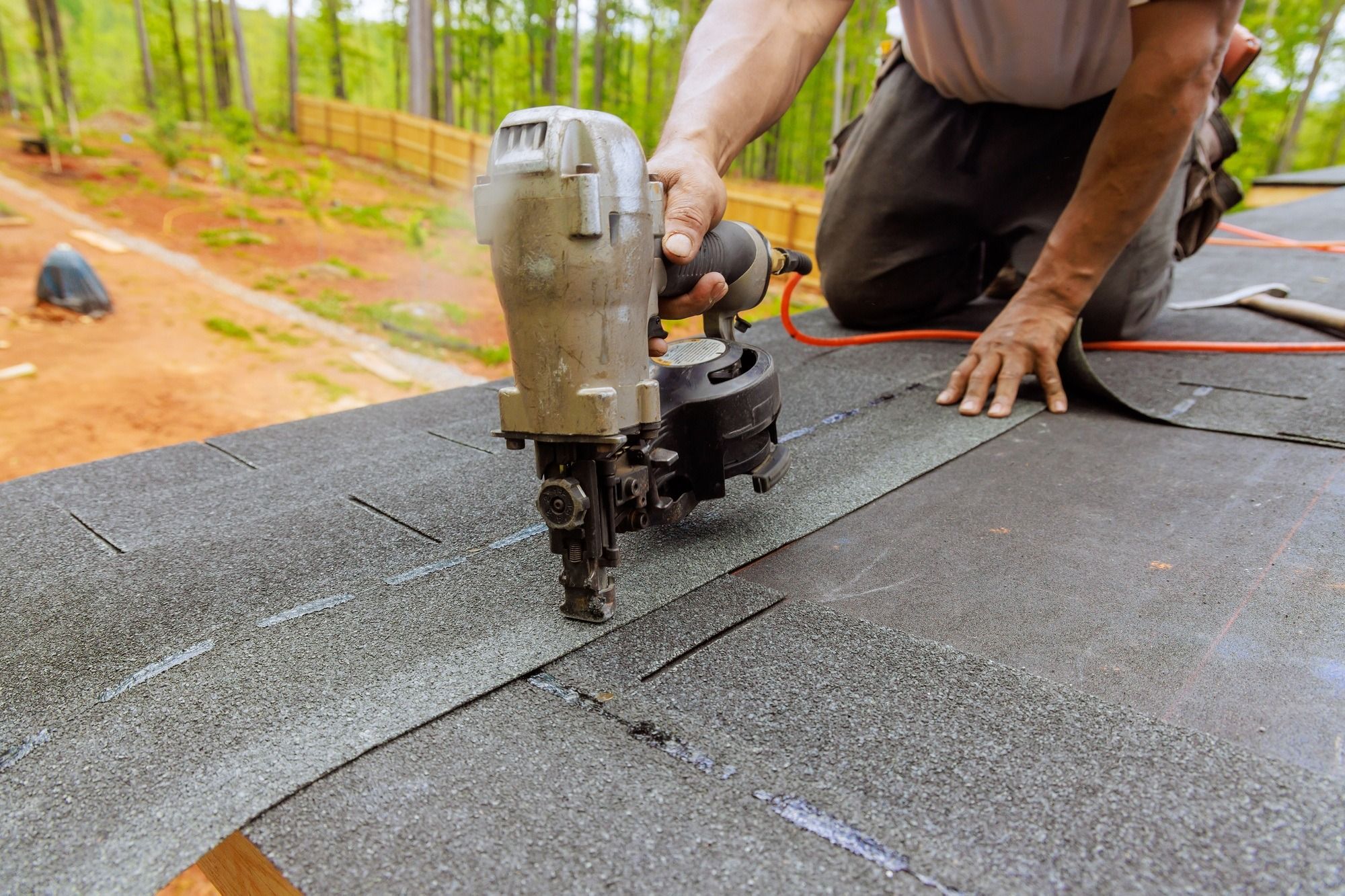 imgi_35_using-an-air-pneumatic-nail-gun-a-roofer-install-new-asphalt-bitumen-shingles.jpg