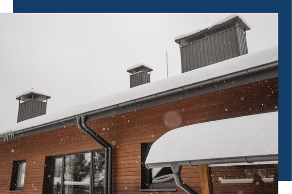 snow accumulating on house roof