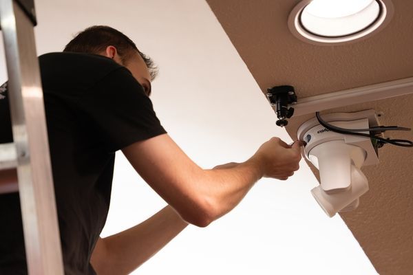 man installing a camera