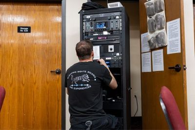 man working on an av system
