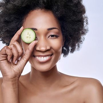 woman with cucumber slice