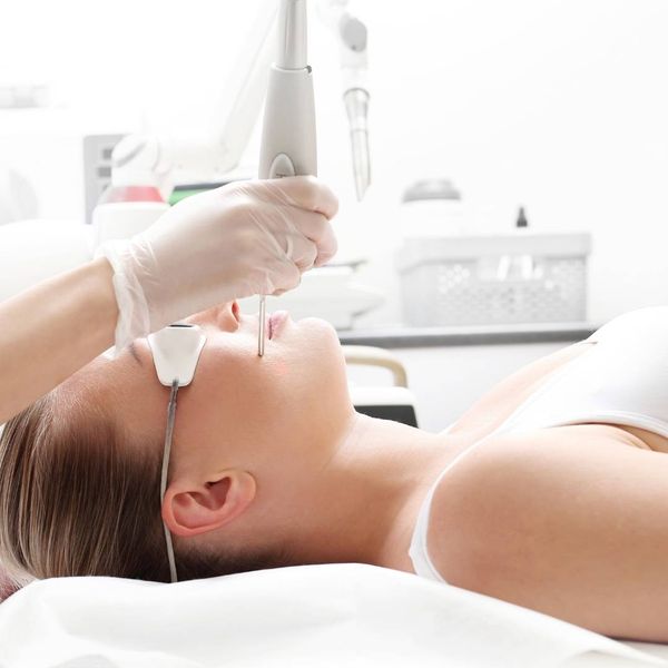 Woman receiving laser facial treatment