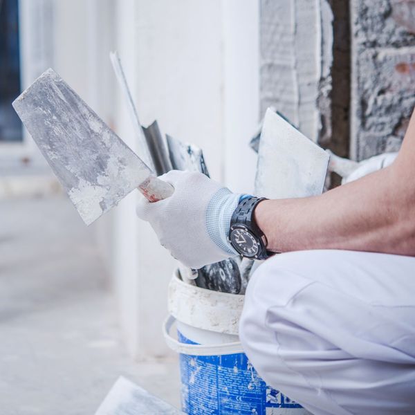 a professional mudding a wall