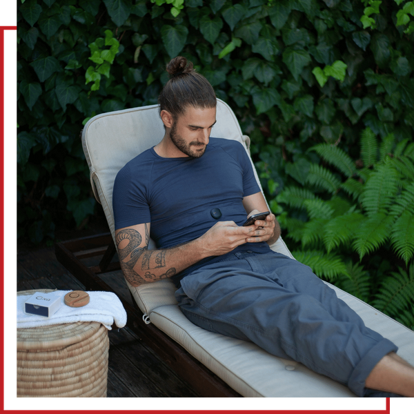Man relaxing outdoors checking crypto mining rewards on a smartphone, illustrating TEXITcoin remote mining access from anywhere.