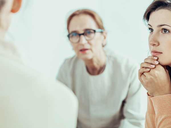 Woman listening closely while other people speak. 