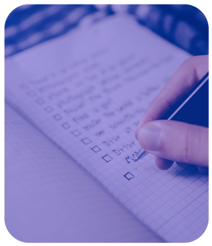 person writing down goals in notebook