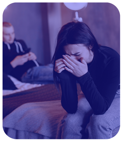 woman crying with man in background on phone