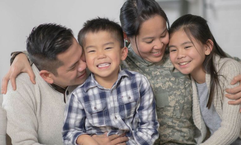 young couple and kids hugging