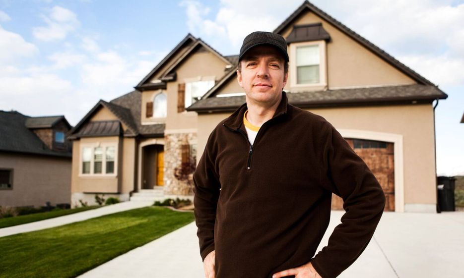 person standing in front of house