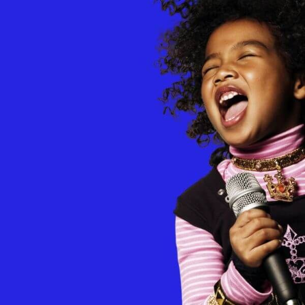 little girl singing into microphone