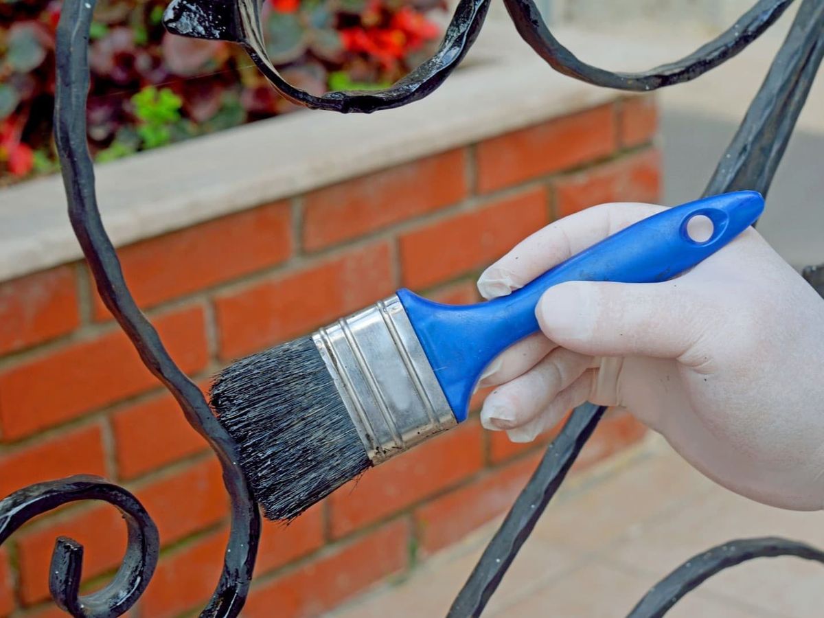 Fence painting in Lincoln Square, Chicago on wrought iron