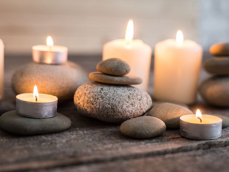 image of stacked river stones and lit candles