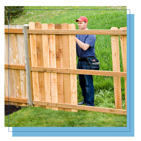 contractor putting up a wood fence