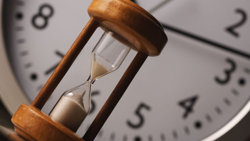 a clock and an hour glass a clock and an hour glass