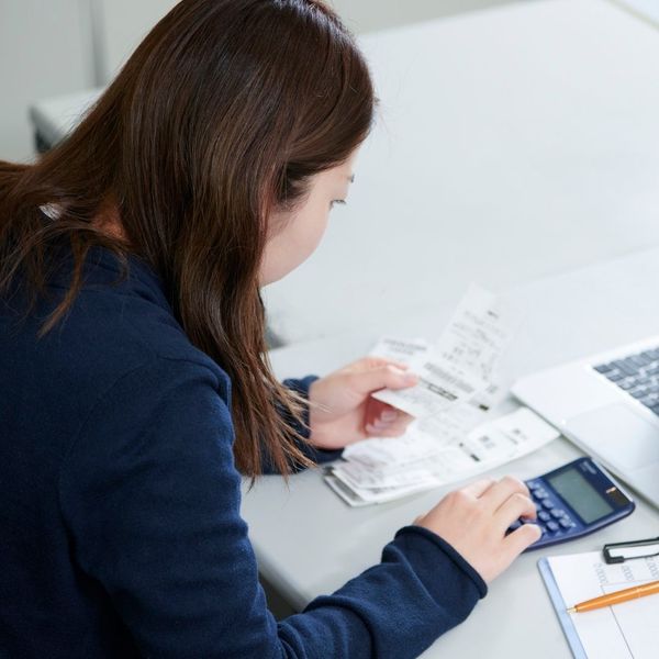 woman looking through bills