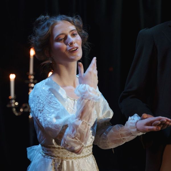 woman singing during a musical