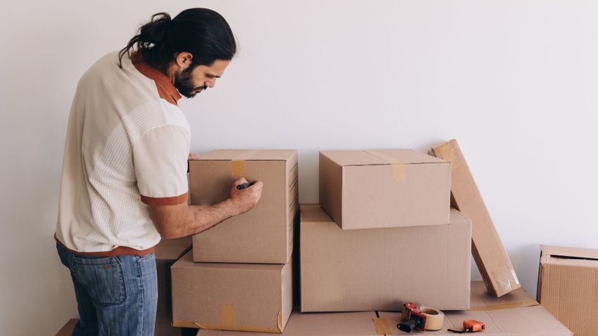man packing boxes