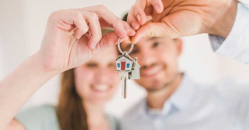 couple holding a key