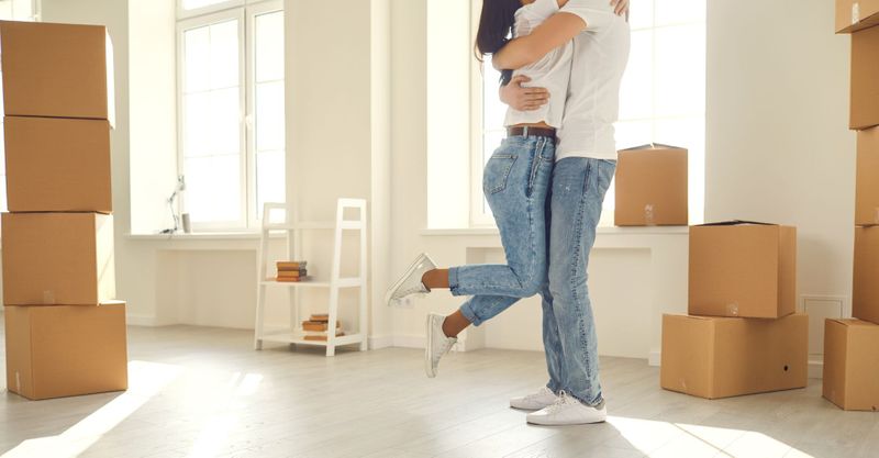 people hugging in a new apartment