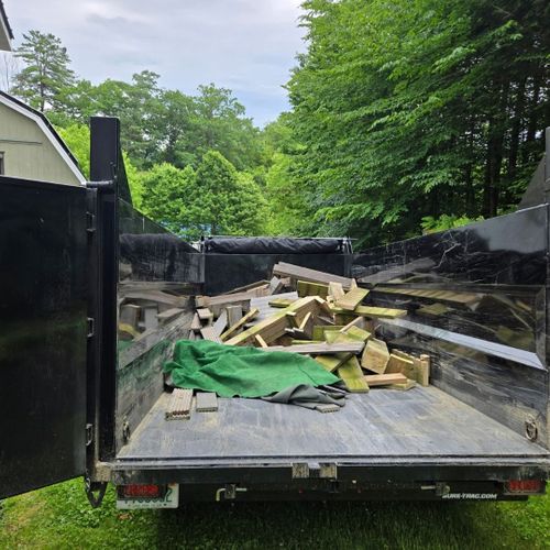 Open utility trailer loaded with boards