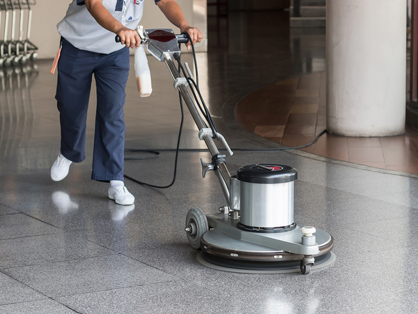 Image of a commercial cleaning crew polishing the floors of an office.