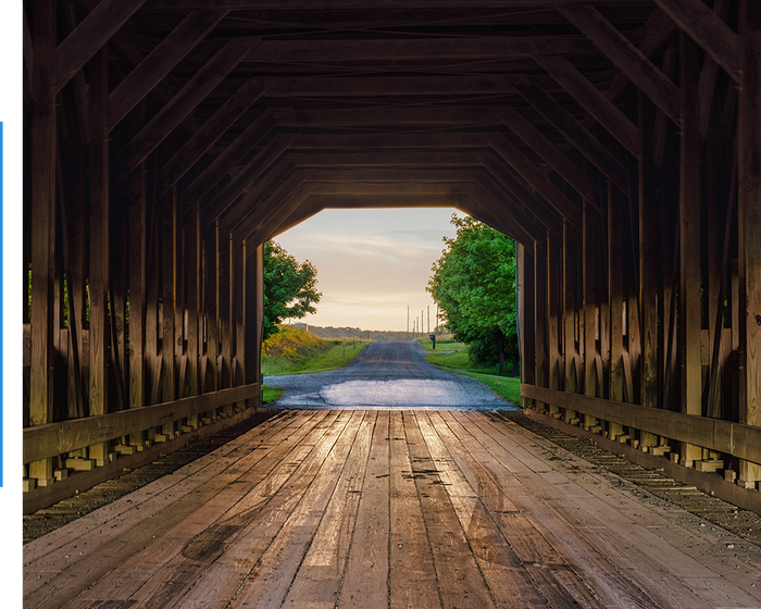 Looking through a historic lumber covered bridge