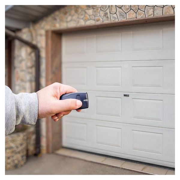 close up of hand clicking garage door opener