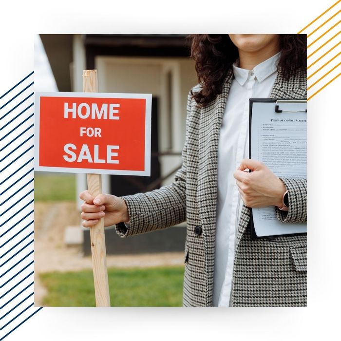 realtor holding "Home for Sale" sign